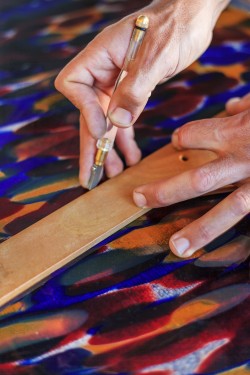 hands cutting German glass LR